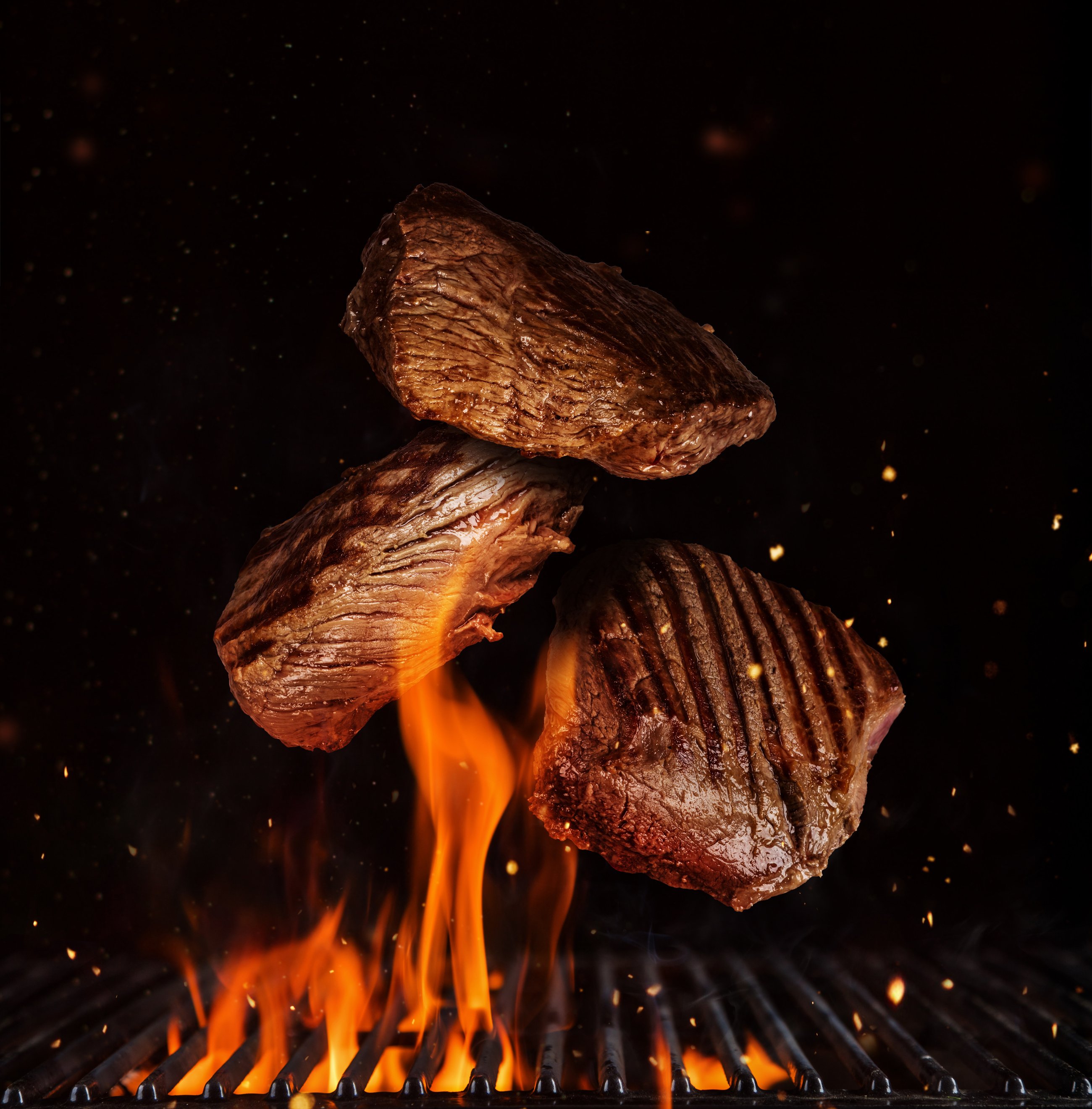 Flying Pieces of Beef Rump Steaks on Black